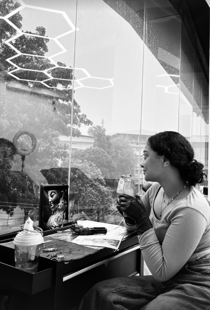 Client reflecting by the studio glass window